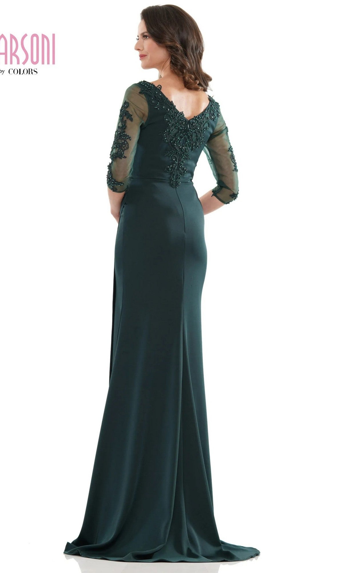 Woman wearing the Marsoni MV1146 long formal dress in dark green with lace sleeves and back detailing, standing and facing away from the camera.